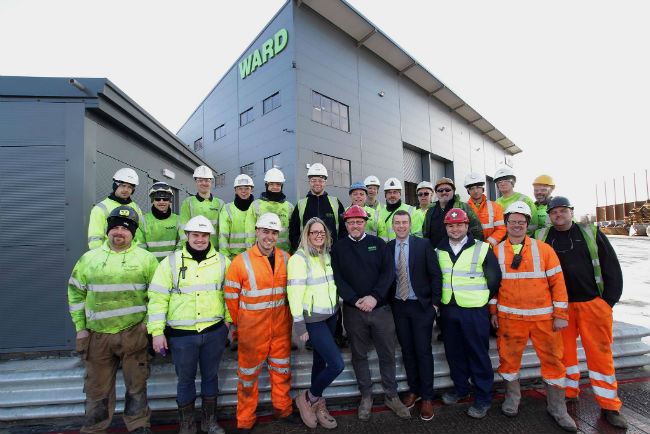 Ward employees pose outside their HQ